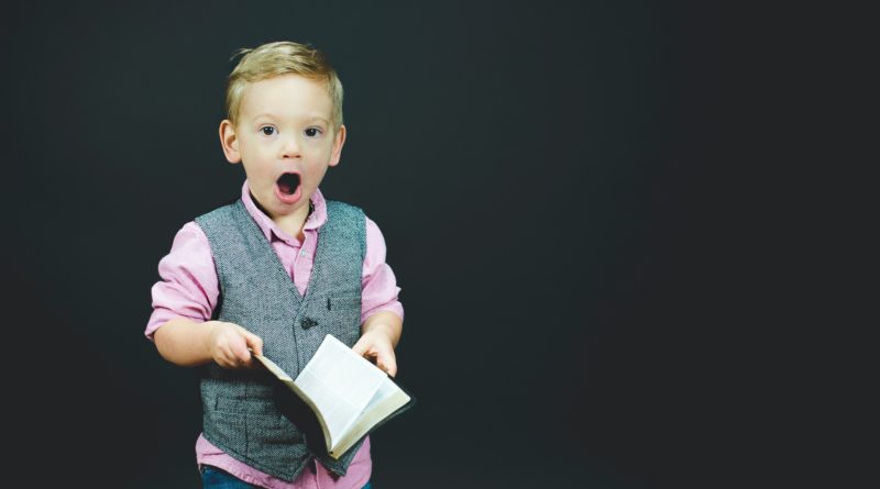 Surprised boy holding Bible